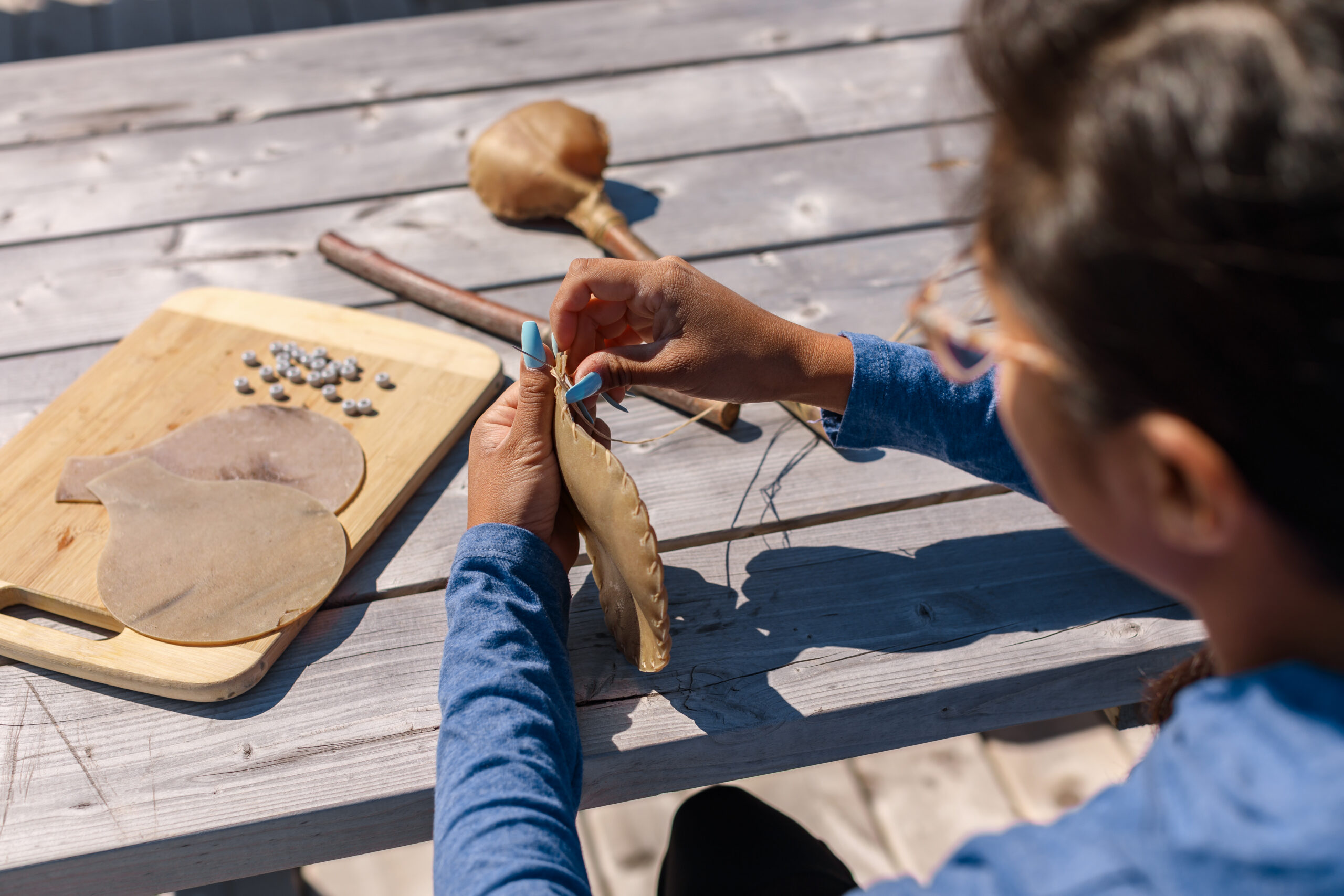 A visitor learning traditional Mi’kmaq craft on Lennox Island