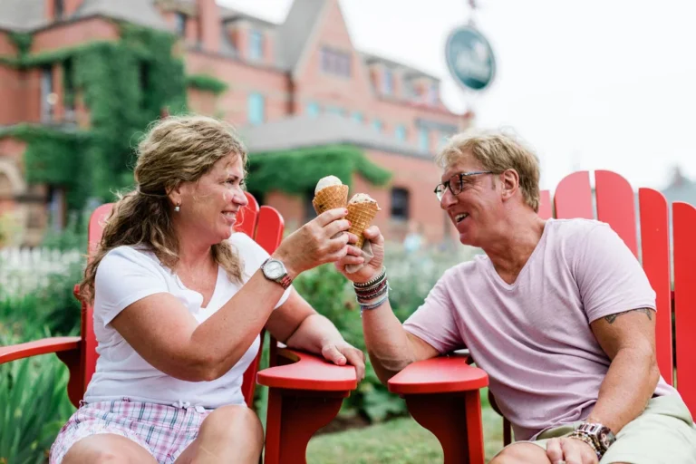 Couple enjoying ice cream cones outside Holman's Ice Cream Parlour in Summerside, Prince Edward Island.