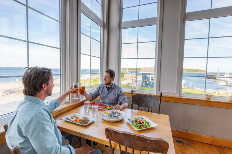 Guests enjoying fresh seafood and waterfront dining at Northport Pier Restaurant in Western Prince Edward Island.