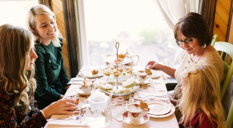 Guests enjoying traditional afternoon tea with sandwiches and pastries at Tyne Valley Teas Café in Western Prince Edward Island.